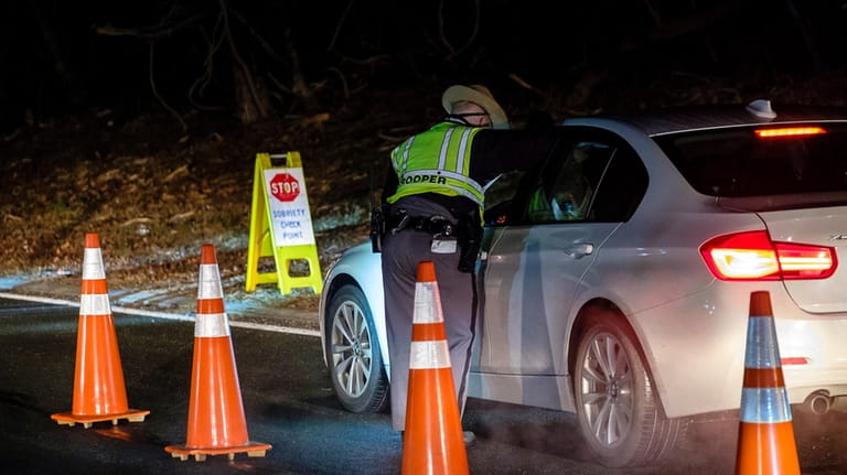 New York State Troopers operate a sobriety checkpoint on the...