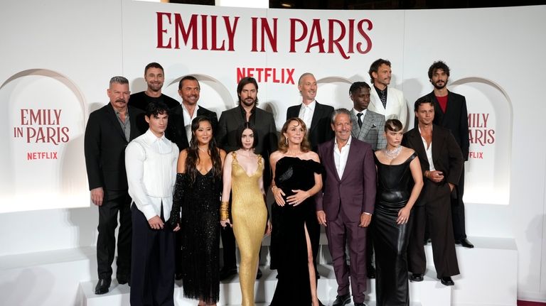 The cast of "Emily in Paris" poses before the premiere...