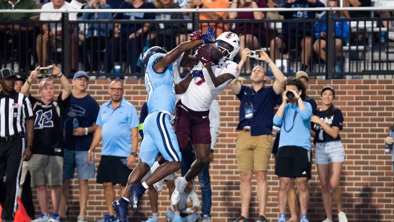 Old Dominion cornerback Dywan Griffin, center left, breaks up a...