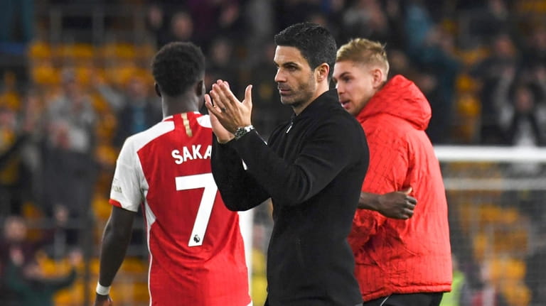 Arsenal's manager Mikel Arteta applauds supporters at the end of...