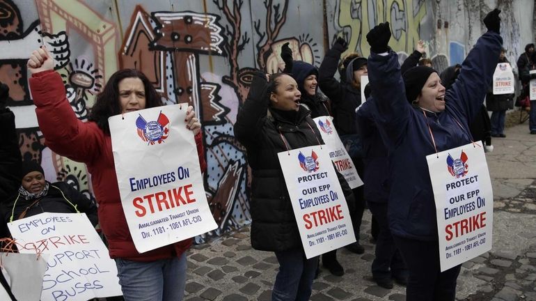 School bus attendants and their supporters walk a picket line...