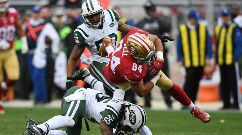 Blake Bell of the San Francisco 49ers is hit by...