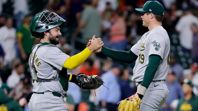 Oakland Athletics catcher Shea Langeliers, left, and closing pitcher Mason...