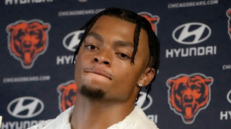 Chicago Bears quarterback Justin Fields listens to a question during...