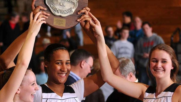 St. Anthony's teammates, from left, #12 Rebecca Musgrove, #24 Symone...