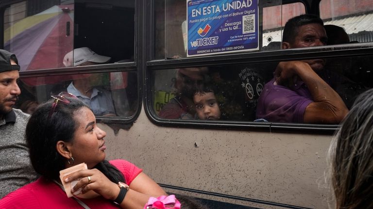 A public bus traverses the Catia neighborhood of Caracas, Venezuela,...