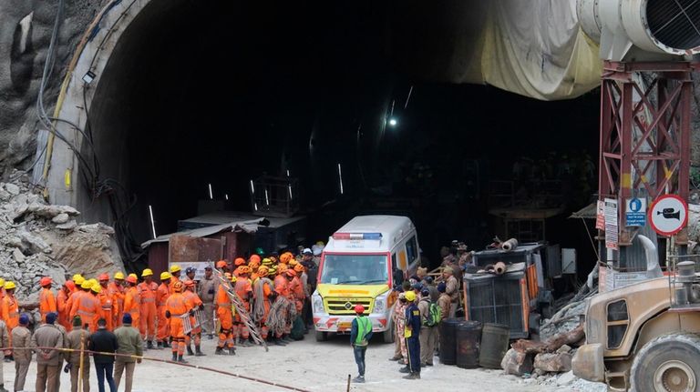 An ambulance waits to carry workers from the site of...