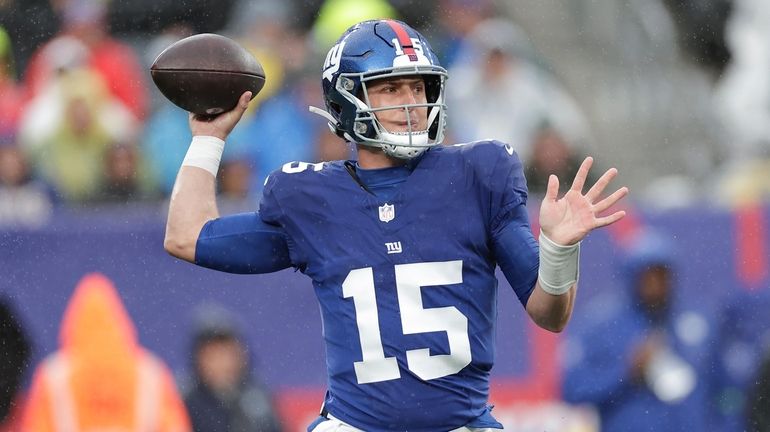 New York Giants quarterback Tommy DeVito (15) passes the ball...