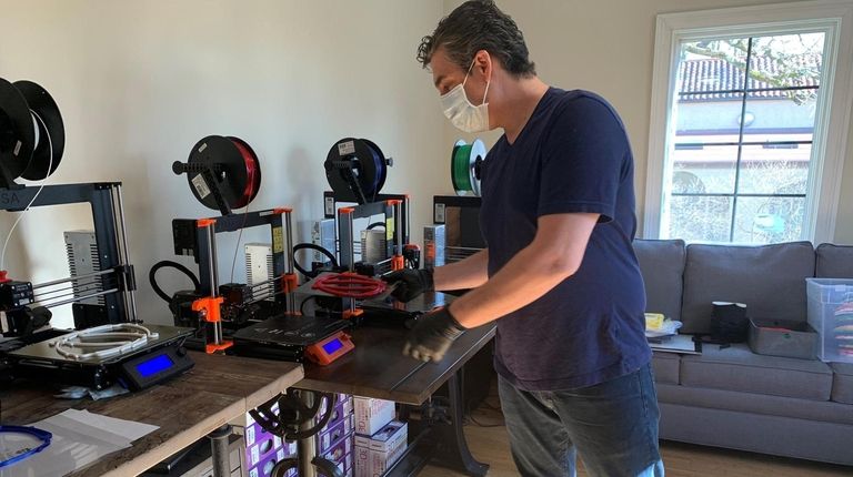 Max Hergenrother uses a 3D printer at his Glen Head home office to...