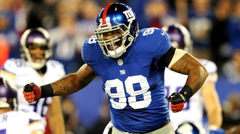 Defensive end Damontre Moore of the New York Giants reacts...