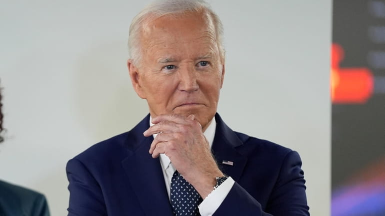President Joe Biden listens during a visit to the D.C....