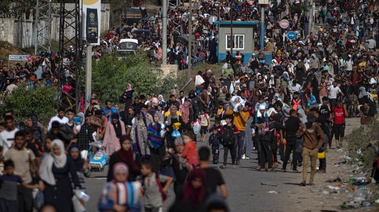 Palestinians flee to the southern Gaza Strip on Salah al-Din...