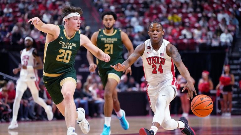 UNLV guard Jackie Johnson III (24) dribbles the ball next...