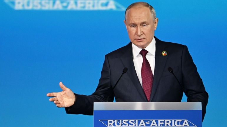 Russian President Vladimir Putin delivers a speech during a plenary...