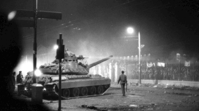 FILE- Army tanks prepare to drive through the gates of...