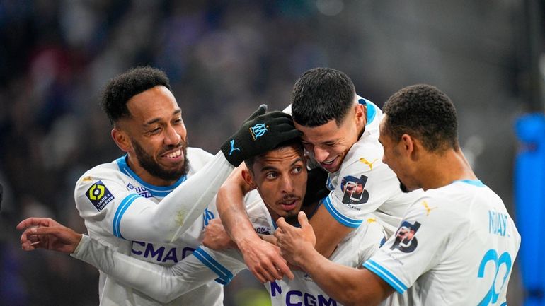 Marseille's Azzedine Ounahi, center, is congratulated after scoring his side's...