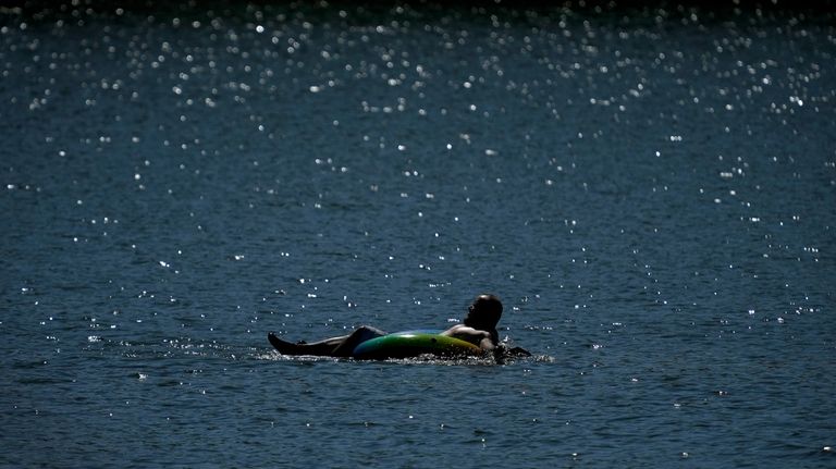 A tuber floats in the lake at Gray's Lake Park...