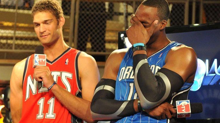 Orlando Magic center Dwight Howard, right, reacts to the comments...