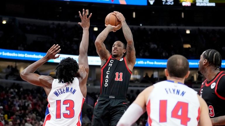 Chicago Bulls' DeMar DeRozan (11) shoots over Detroit Pistons' James...