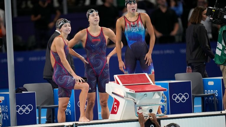 The United States team reacts after their second place finish...