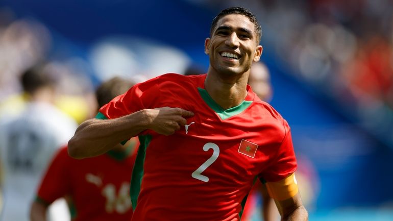 Morocco's Achraf Hakimi celebrates scoring his side's third goal during...