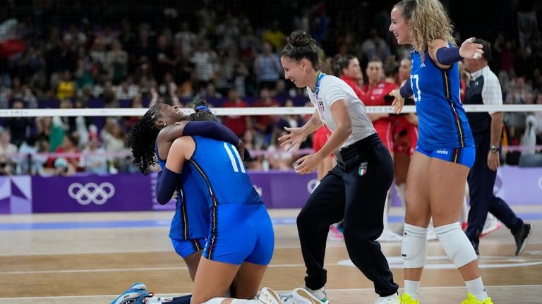 Italy's team celebrate at the end of the game against...