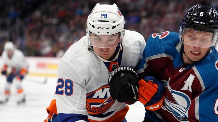 Islanders left wing Michael Dal Colle, left, pursues the puck into...