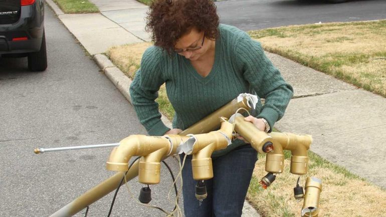 Ann Radish collects the remains of her father's Menorah lawn...