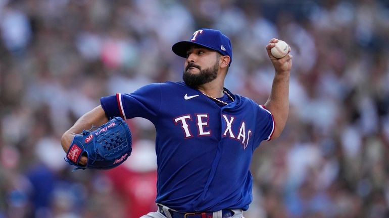 Texas Rangers starting pitcher Martin Perez works against a San...