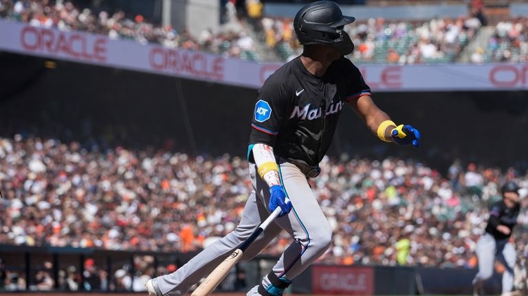 Miami Marlins' Jesús Sánchez watches his sacrifice fly during the...