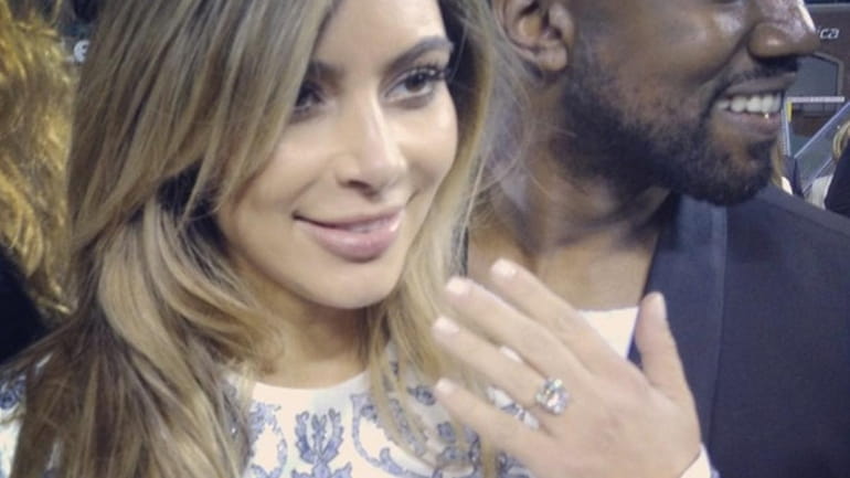 Kim Kardashian and Kanye West after he proposed on her...