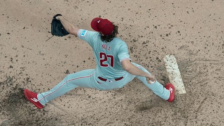 Philadelphia Phillies pitcher Aaron Nola throws during the fifth inning...