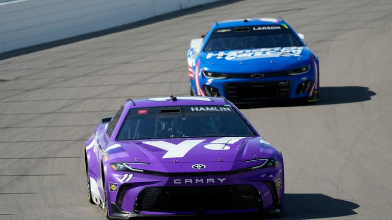 Denny Hamlin, front, drives followed by Kyle Larson during a...
