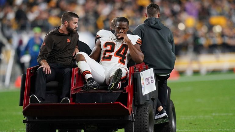 Cleveland Browns running back Nick Chubb is cared off the...