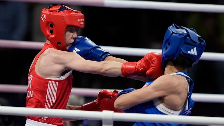 Britain's Charley Davison, left, and Turkey's Hatice Akbas exchanges punches...