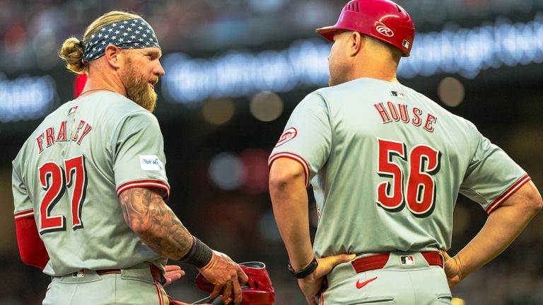 Cincinnati Reds' Jake Fraley (27) talks with third base coach...