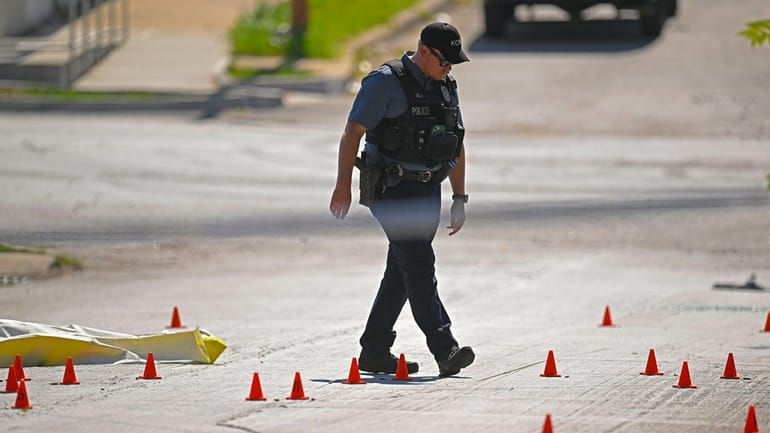 Evidence markers filled the street as police were investigating the...