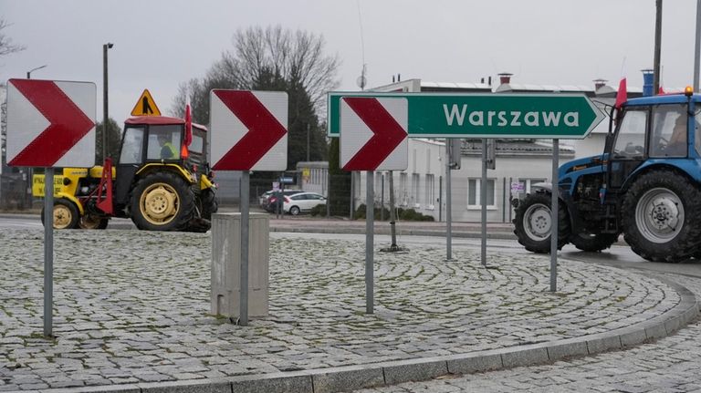 Polish farmers drive tractors in a convoy in Minsk Mazowiecki,...