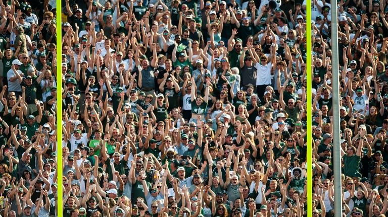 Michigan State fans react after defensive back Charles Brantley scored...