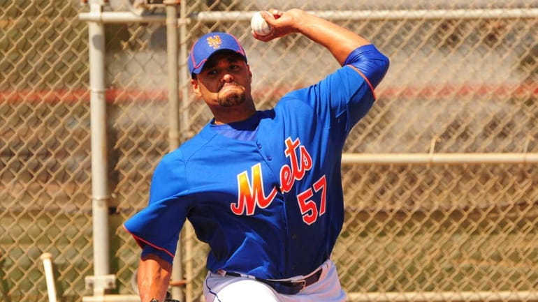 Mets starting pitcher Johan Santana throws a bullpen session during...