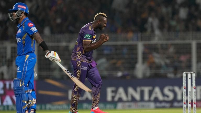 Kolkata Knight Riders' Andre Russell celebrates the wicket of Mumbai...