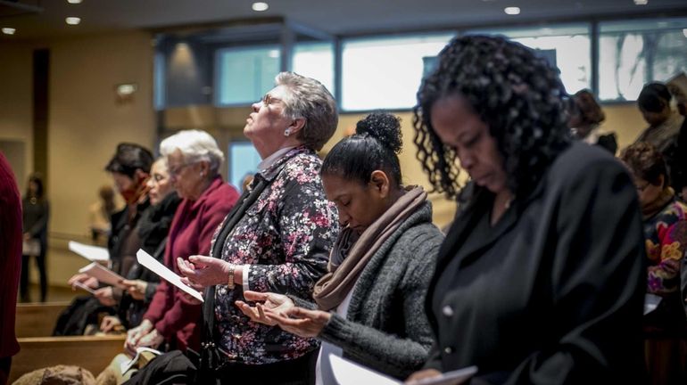 People listen to a "Service of Justice and Reconciliation" at...