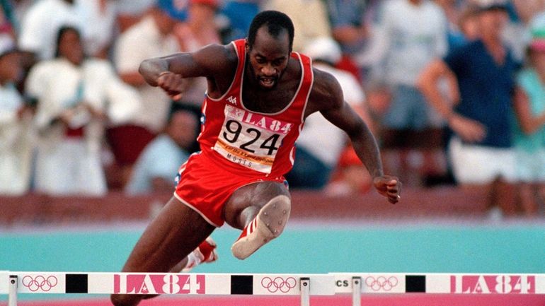 United States' Edwin Moses jumps a hurdle on his way...