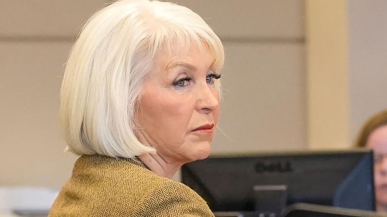 Tina Peters, former Mesa County, Colo., clerk, listens during her...