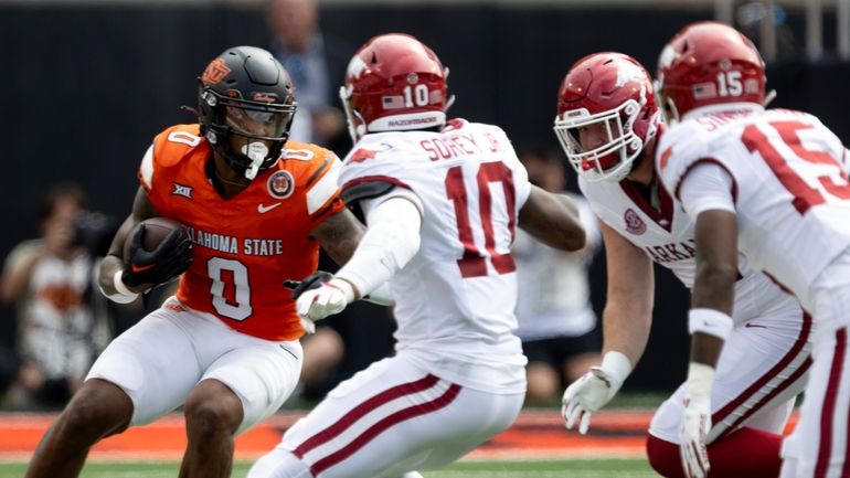 Oklahoma State running back Ollie Gordon II (0) runs into...