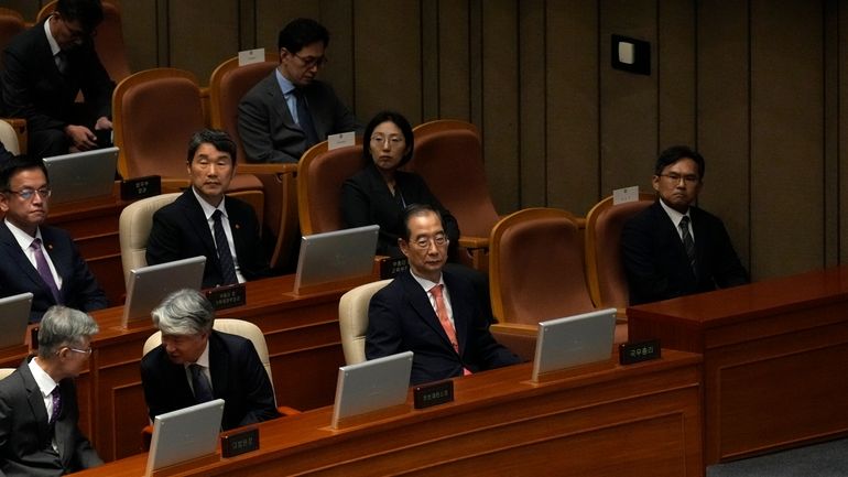 South Korean Prime Minister Han Duck-soo, center right in front,...