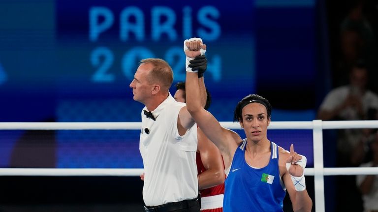 Algeria's Imane Khelif gestures after defeating Thailand's Janjaem Suwannapheng in...