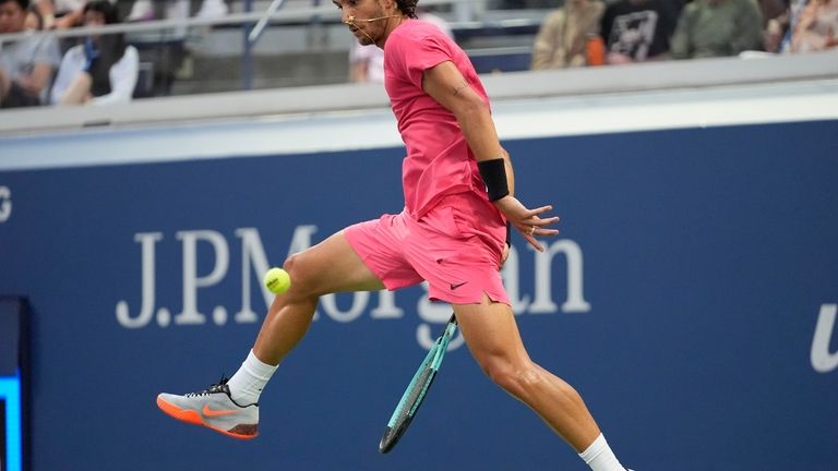 Lorenzo Musetti, of Italy, returns a shot to Brandon Nakashima,...