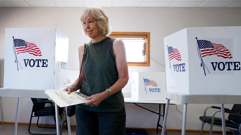 Frances Kuncel, of Ackworth, Iowa, prepares to cast her ballot...