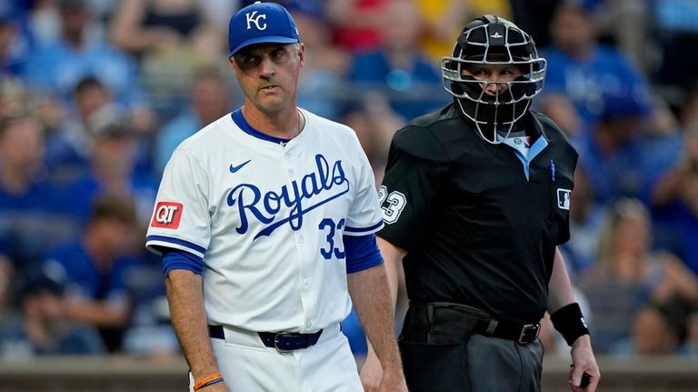 Kansas City Royals manager Matt Quatraro walks back to the...